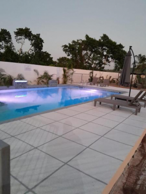 Oricha Villa- Stylish 2-Bedroom Retreat with AC & Pool Access